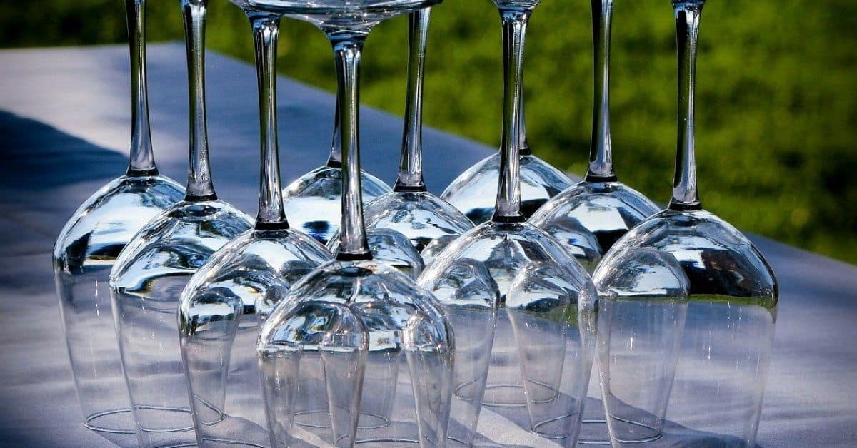 Nine wine glasses standing upside-down on a table