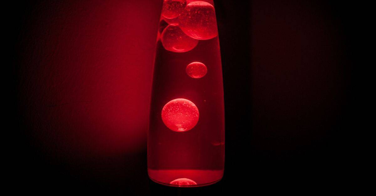 A red lava lamp in a dark room