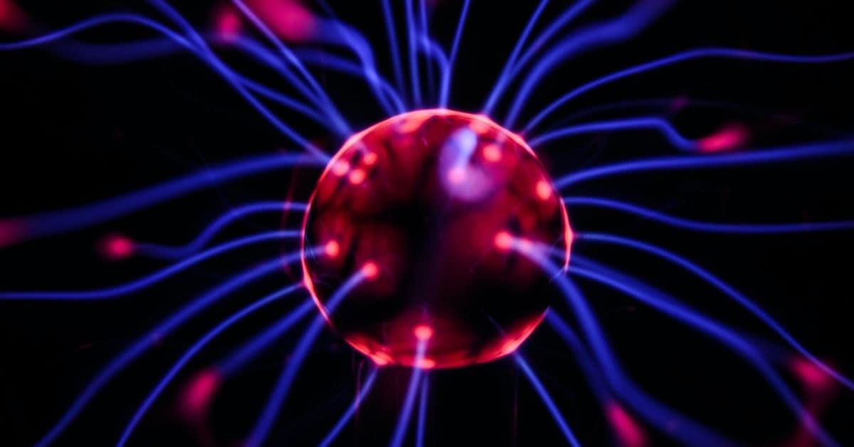 Close up shot of a plasma ball in red and blue lights